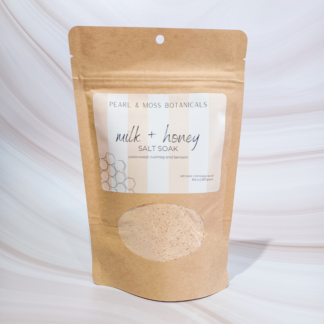 Front of bag: BENZOIN + CEDARWOOD + NUTMEG  Warm and sweet, the Milk + Honey SALT SOAK helps to relieve sore muscles and soothe tired skin. Softly scented with benzoin, cedarwood and nutmeg essential oils, the Milk + Honey SALT SOAK contains antibacterial honey powder to help maintain skin clarity and assist with keeping breakouts away.